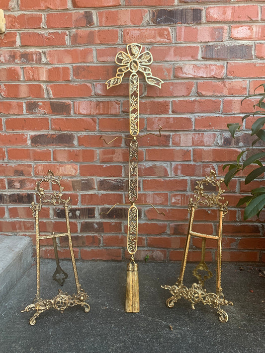 Brass plate wall stand 40” tall featuring ornate flowers and leaves with an incredible bow and tassels details!