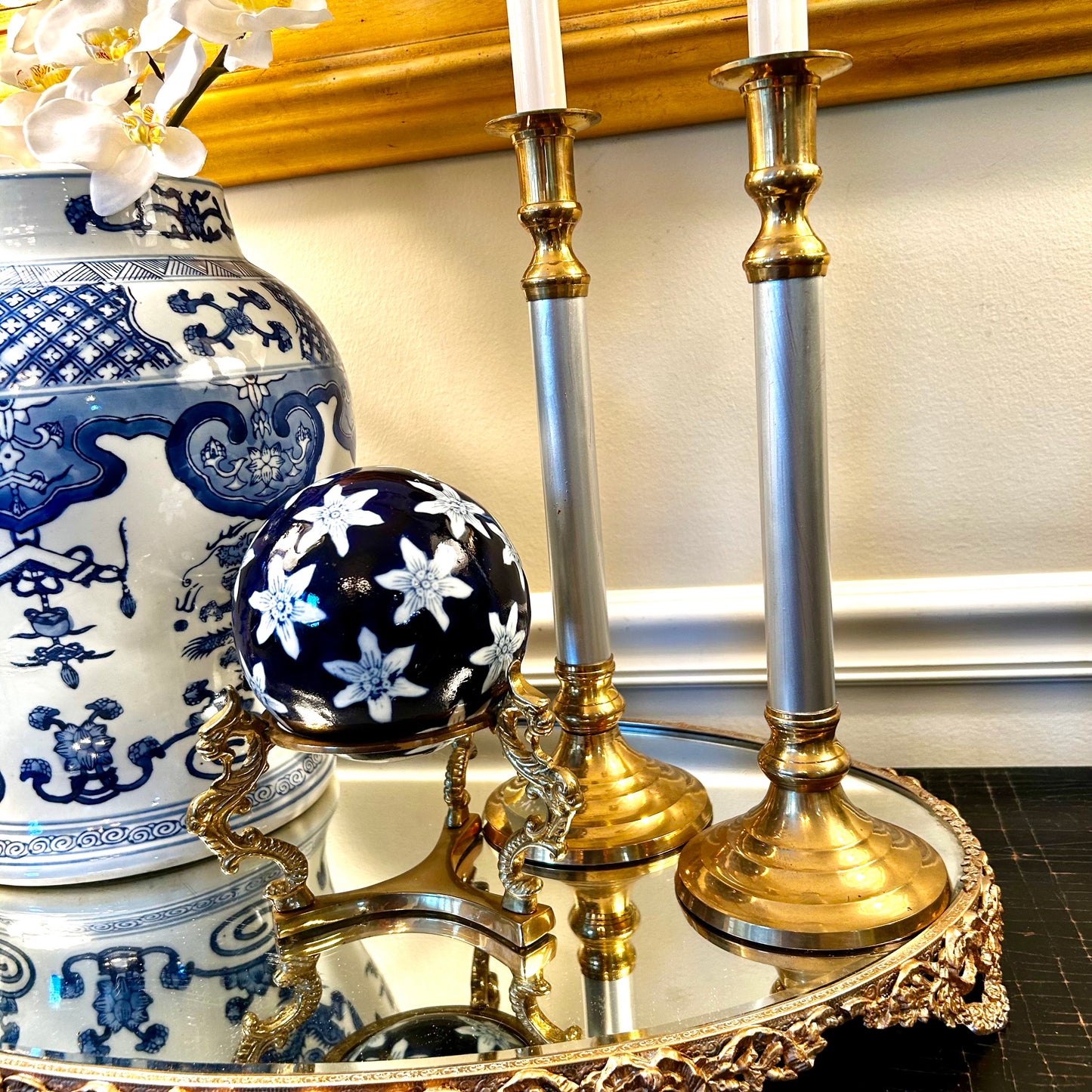 Pair of statuesque mid century brass and silver plate candlestick holders