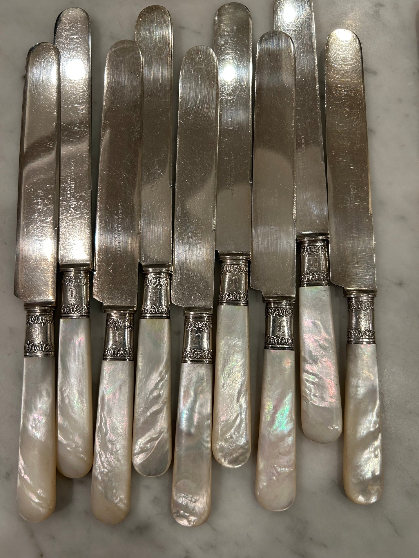 12 Pearl Handled knives All with Sterling Bands!  9 are the Same and 3 are little different, but all Beautiful!