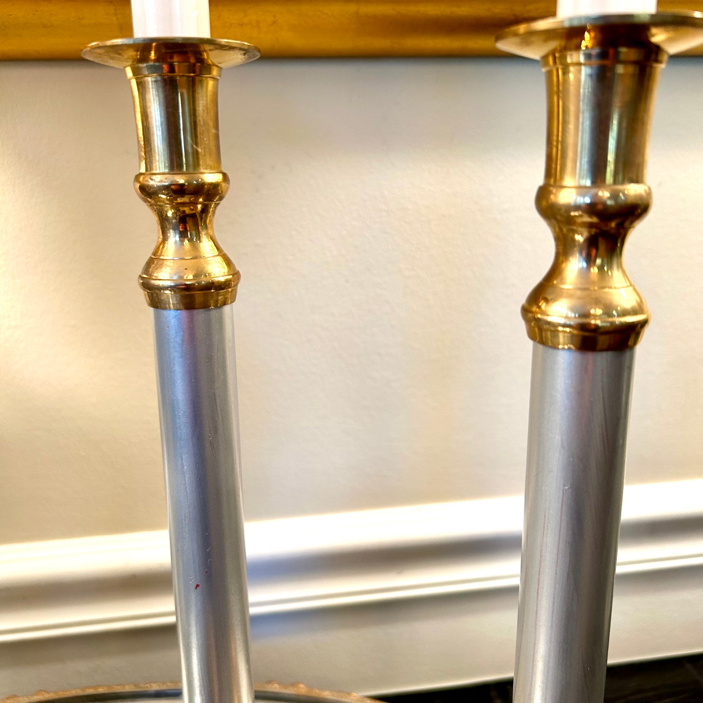 Pair of statuesque mid century brass and silver plate candlestick holders