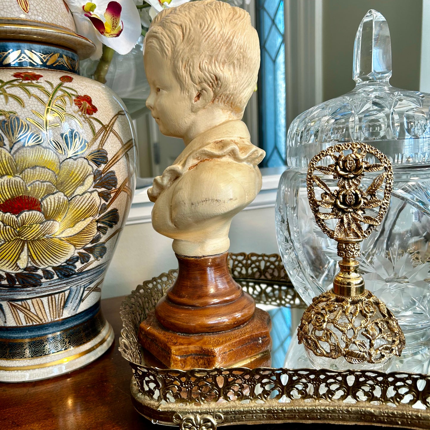 Lovely vintage statue bust of young boy in a puffy shirt in antique ivory .