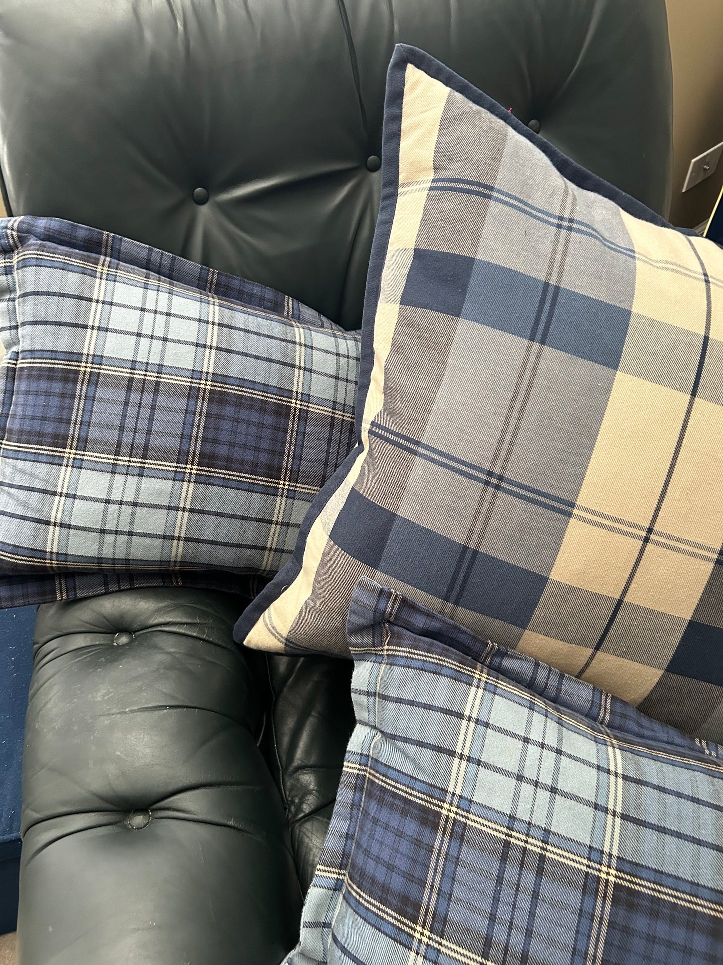 Set of three traditional plaid throw pillows.