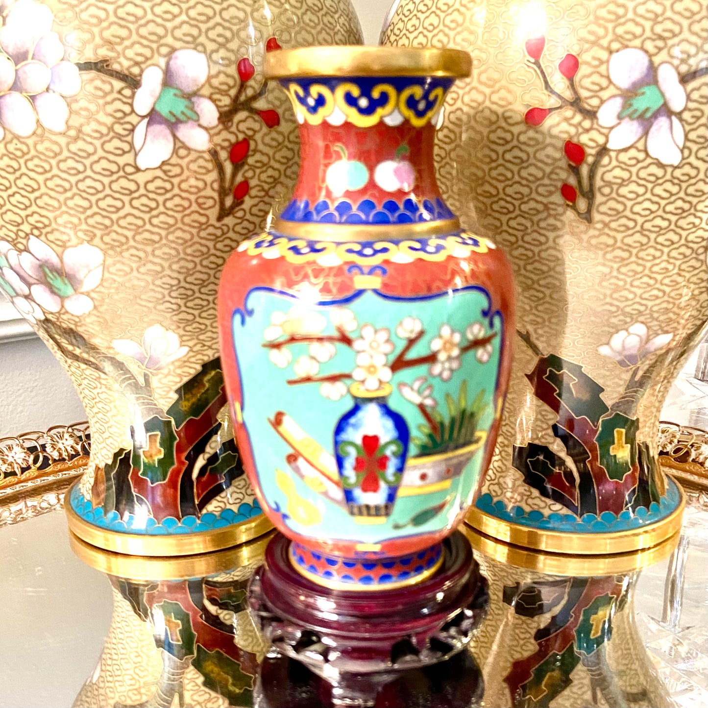 Vibrant vintage brass cloisonné vase on wood stand