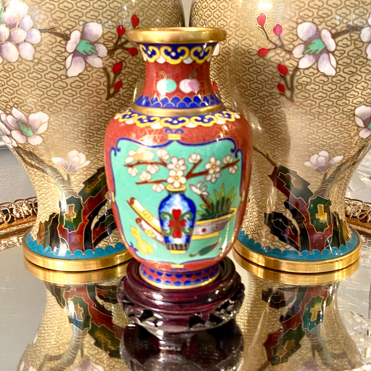 Vibrant vintage brass cloisonné vase on wood stand