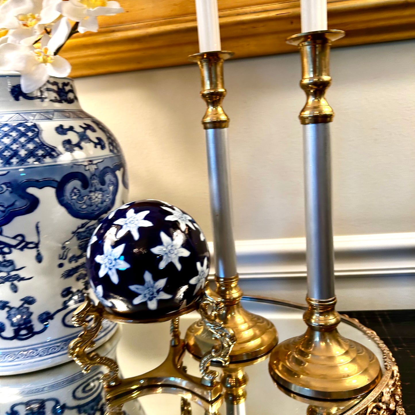 Pair of statuesque mid century brass and silver plate candlestick holders