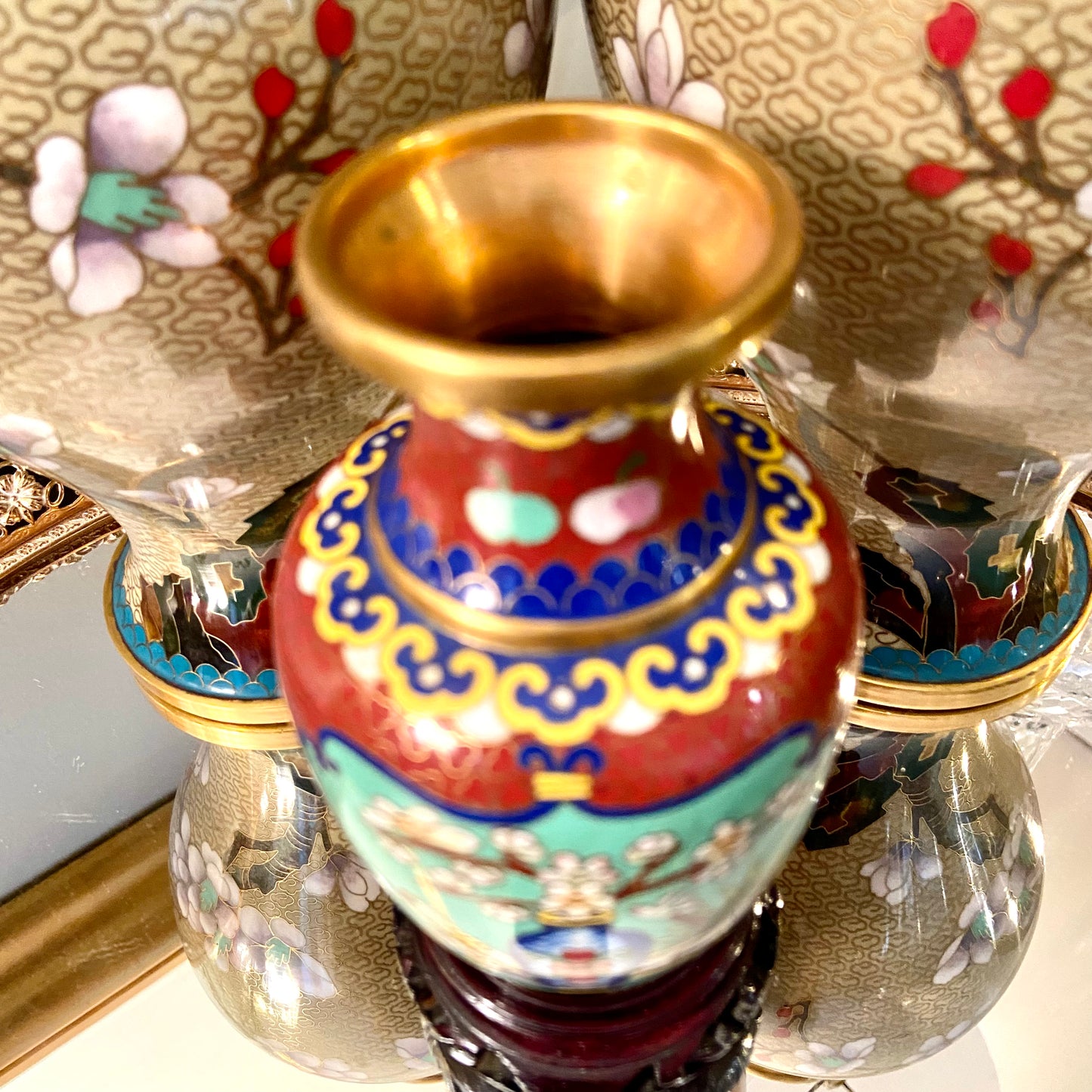 Vibrant vintage brass cloisonné vase on wood stand