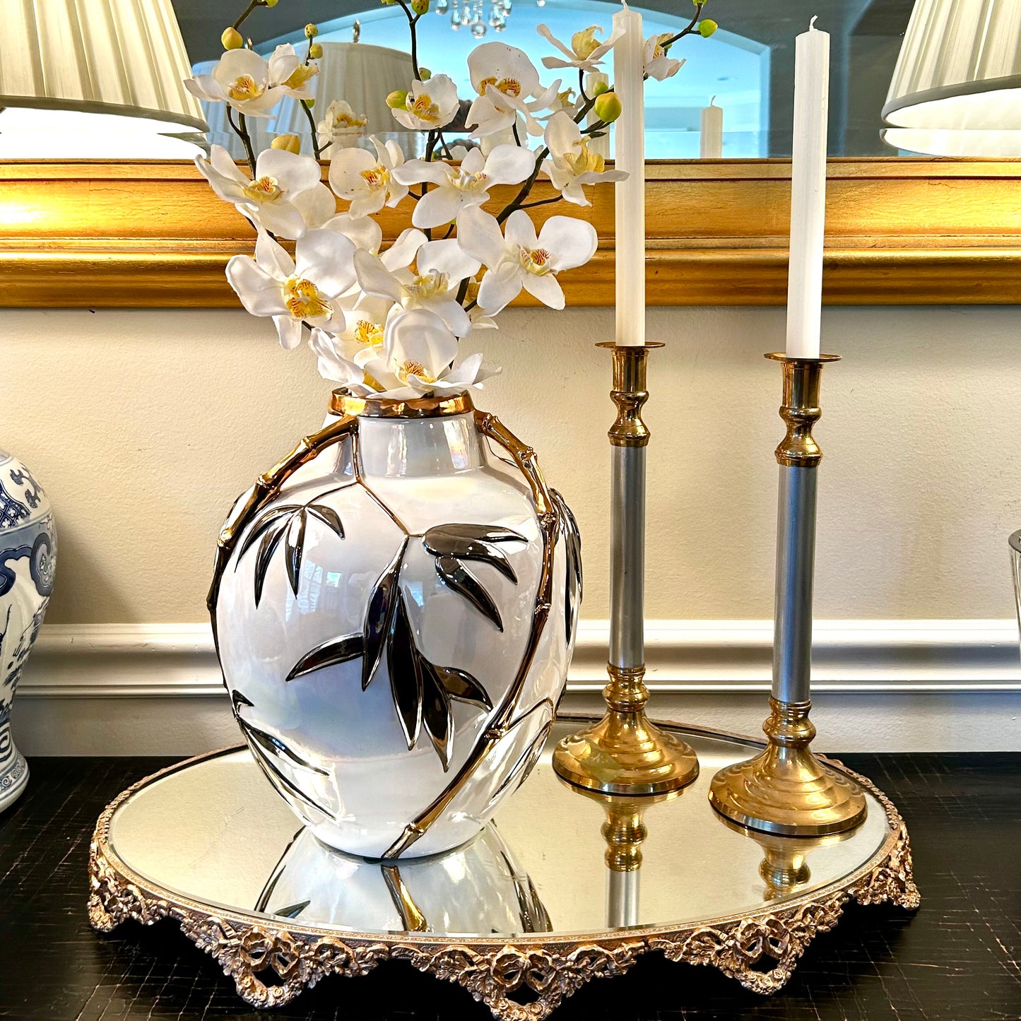 Pair of statuesque mid century brass and silver plate candlestick holders