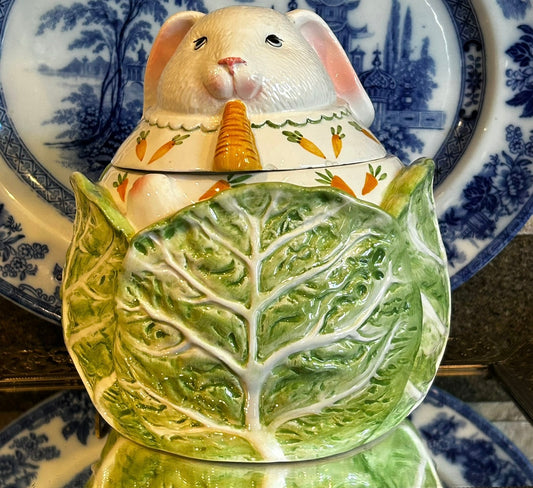 Ample bunny rabbit snuggled in cabbage cookie jar with lid