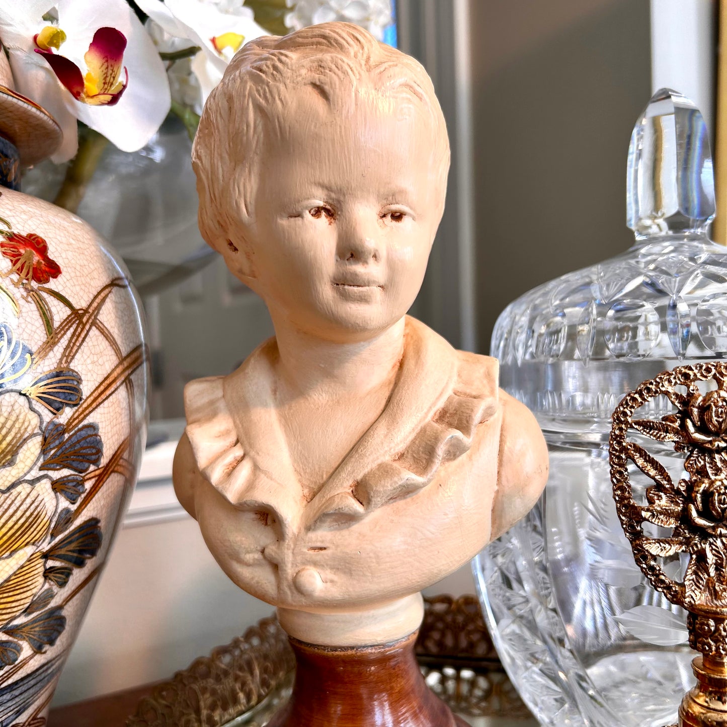 Lovely vintage statue bust of young boy in a puffy shirt in antique ivory .