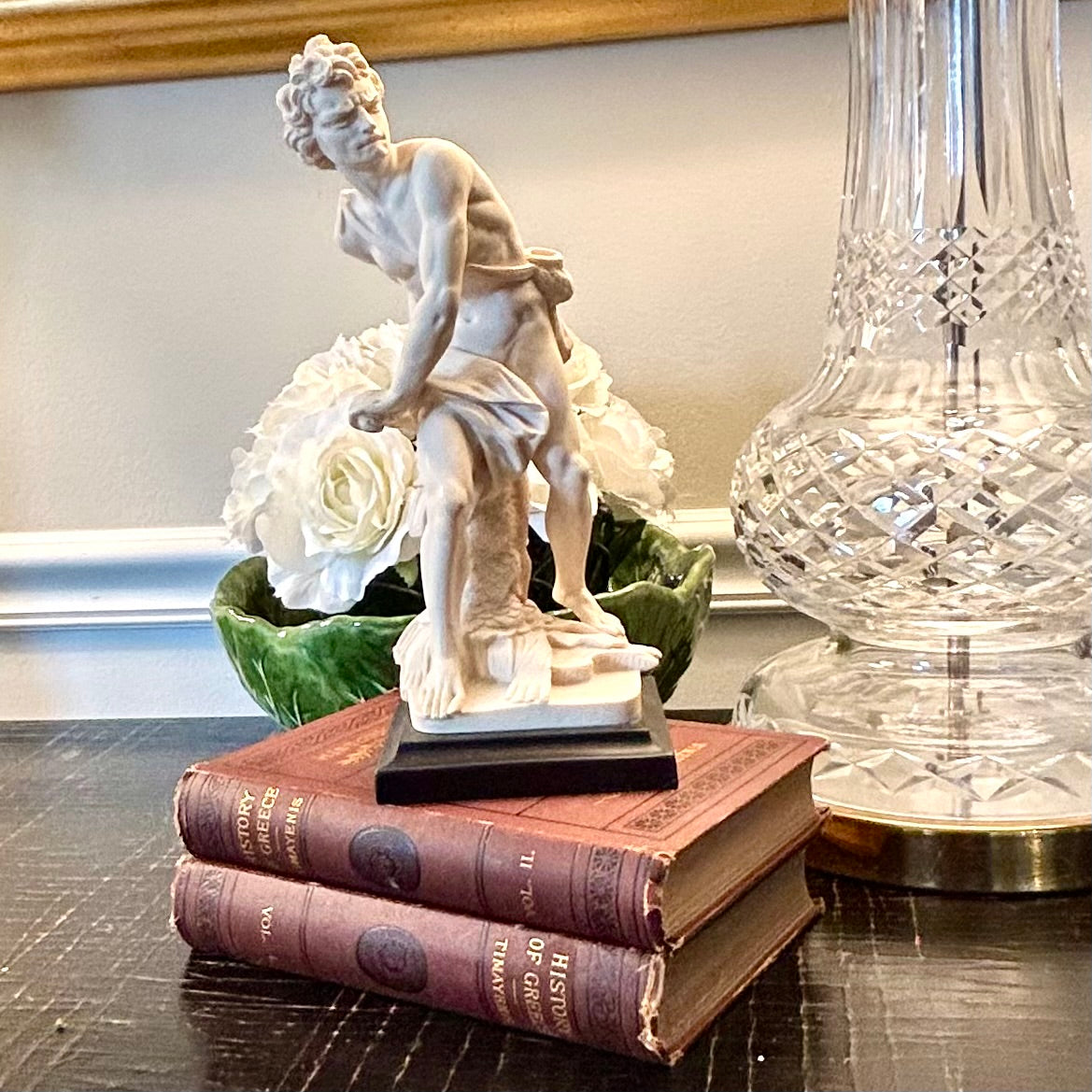 Neoclassical inspired masculine hunter vintage statue in pedestal.