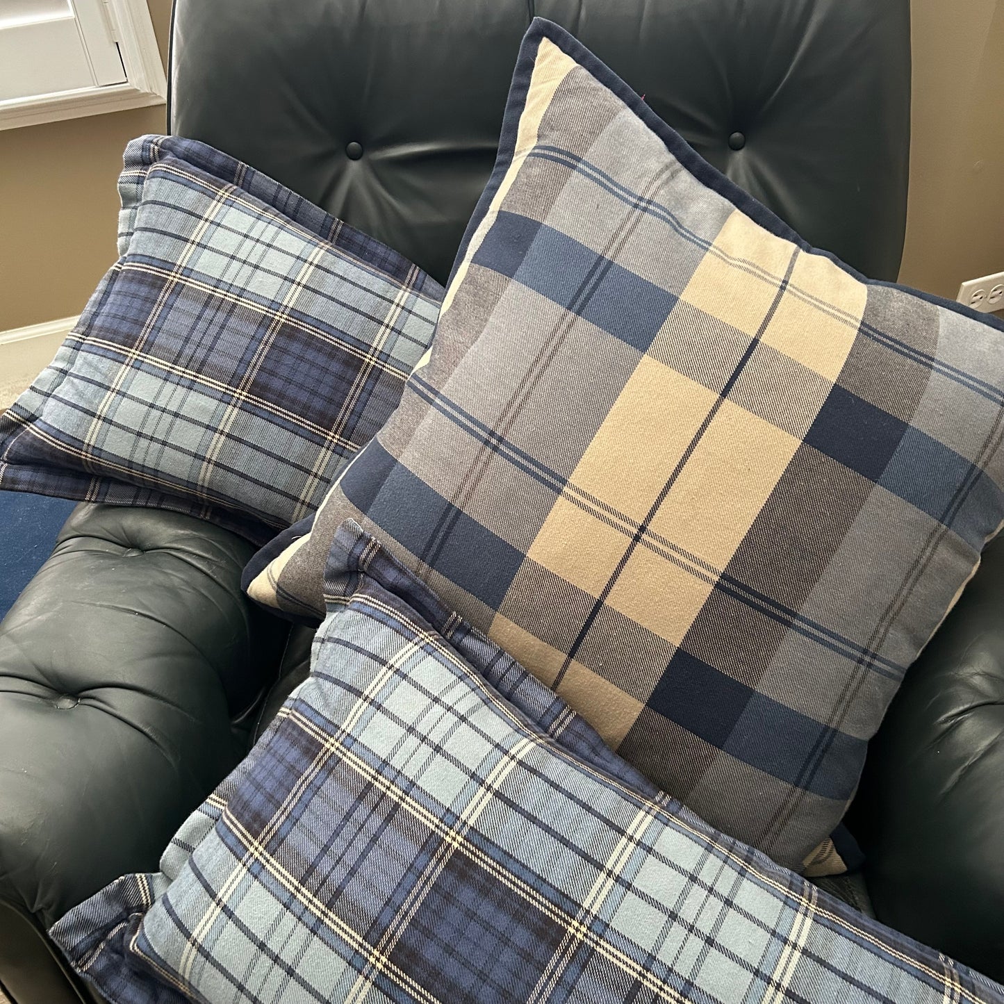 Set of three traditional plaid throw pillows.