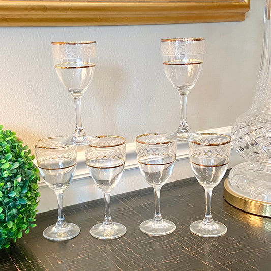 Beautiful set of 7 vintage Italian wine glasses with gold geometric bands.